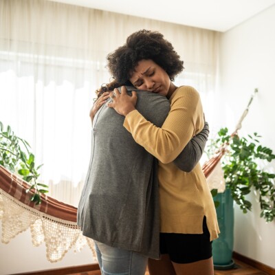 A woman embraces her friend who is going through grief.