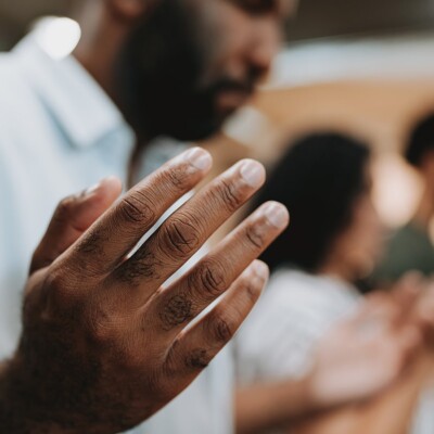 Group of people praying with their hands opened up to God.
