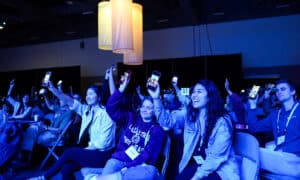 Many Navigators staff hold up their phones, showing people who they have discipled in the past.