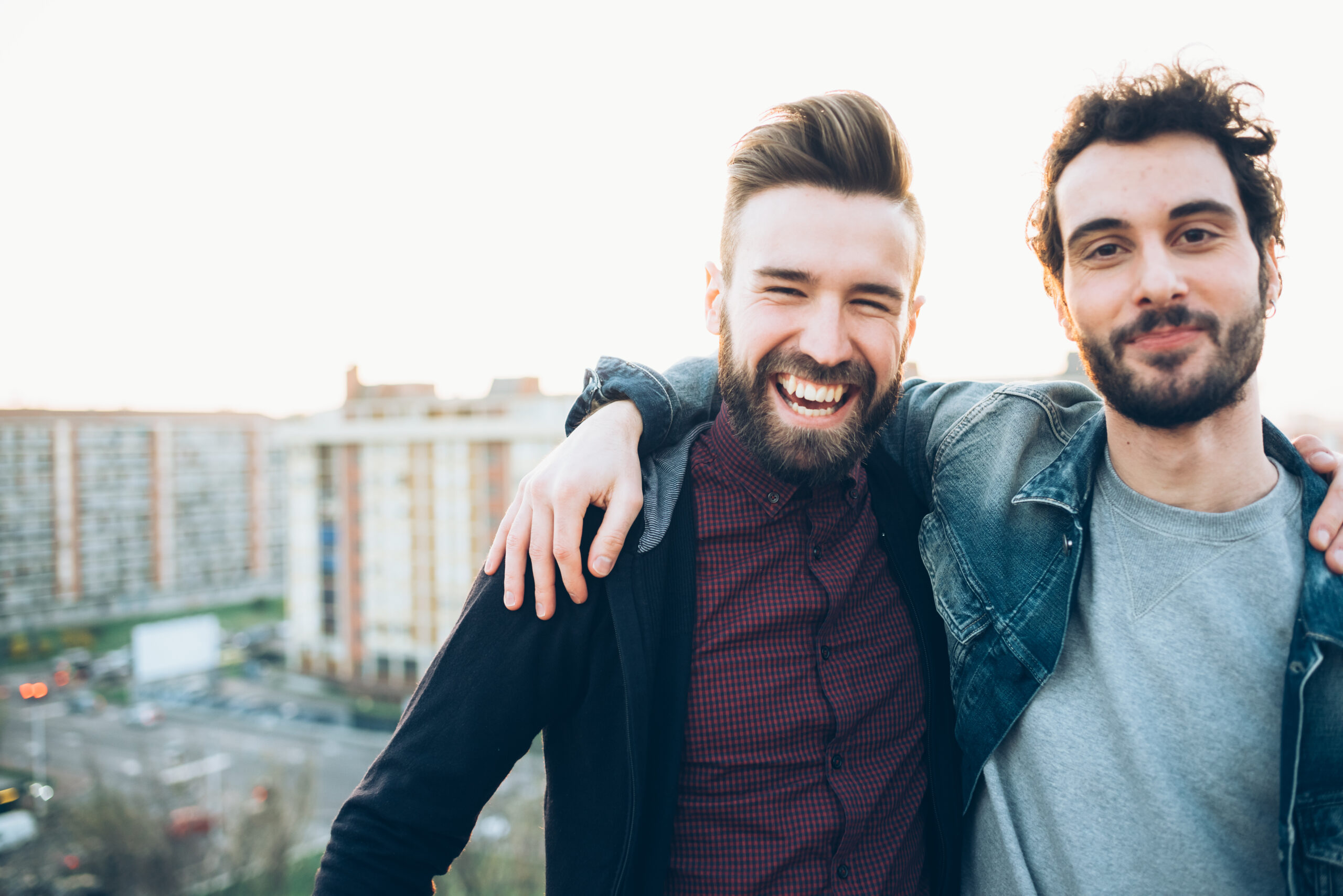 Portrait of two young men, on roof, smiling Navigators men intentionally encouraging each other in discipleship through a Navigators Digital Discipleship Journey.